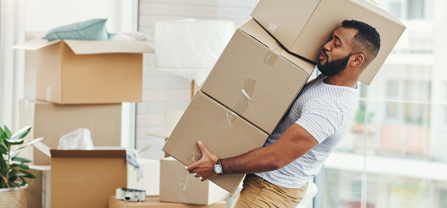 Man carrying three boxes